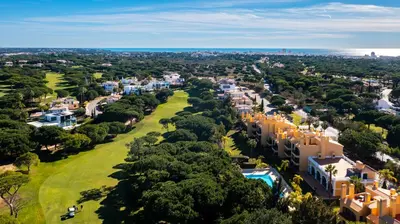 an aerial view of a city with trees and buildings at F5 Vila Sol AI Pool & Golf in Vilamoura in Quarteira