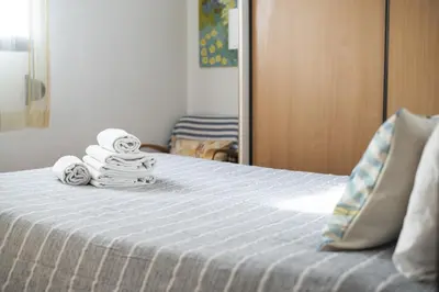 a bedroom with a bed with towels on it at Ancora Mar - Vilamoura Marina by HD in Vilamoura