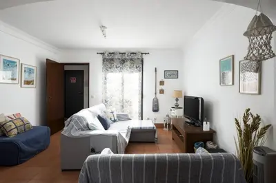 a living room with a couch and a tv at Ancora Mar - Vilamoura Marina by HD in Vilamoura