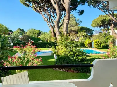 a view of a garden with a swimming pool at Solar Vilamoura Relaxing Apartment Stay in Quarteira