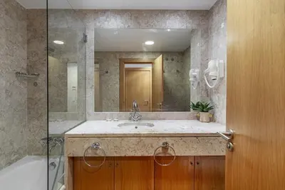 a bathroom with a sink and a large mirror at F5 Vila Sol Q Pool & Golf in Vilamoura in Quarteira