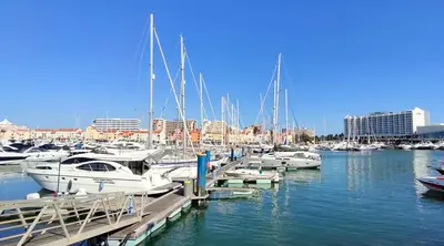 a tennis court in front of a building at Sunny Condo facing the pool by Algarve Dream Holidays in Quarteira