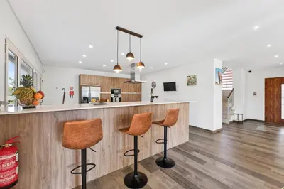 a kitchen with a counter and two stools at a bar at Villa Joya in Almancil