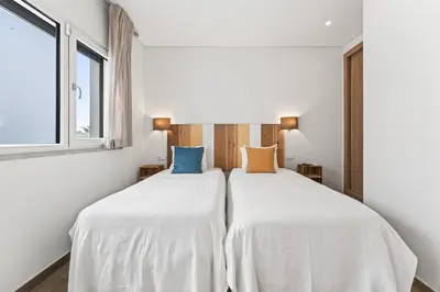 two beds in a room with white walls and windows at Villa Joya in Almancil