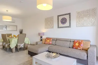 a living room with a table and a couch at #354 Vitismar AU by Home Holidays in Guia