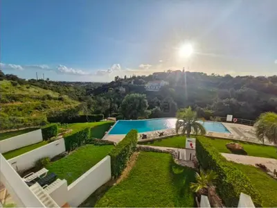a patio with a table and chairs on a balcony at Terras Novas Paradise - Albufeira in Albufeira