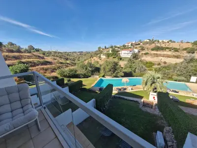 a bedroom with a white bed with two pillows at Terras Novas Paradise - Albufeira in Albufeira