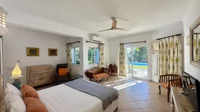a bedroom with a bed and a living room at Pinheiro Manso by Check-in Portugal in Albufeira