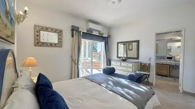 a bedroom with a bed and a window and a sink at Pinheiro Manso by Check-in Portugal in Albufeira