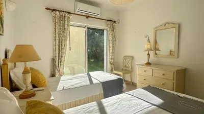 a bedroom with two beds and a mirror and a window at Pinheiro Manso by Check-in Portugal in Albufeira