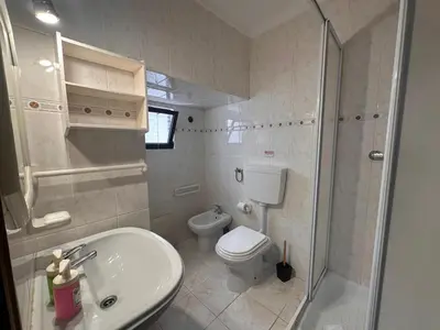 a bathroom with a toilet and a sink and a shower at Al-Gharb House - Vista Mar in Albufeira