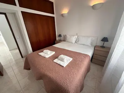 a bedroom with a bed with two towels on it at Al-Gharb House - Vista Mar in Albufeira