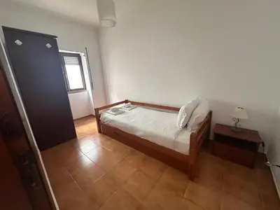 a small bedroom with a bed and a window at Al-Gharb House - Vista Mar in Albufeira
