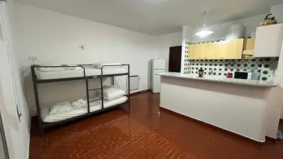 a room with two bunk beds and a kitchen at Blife Josya private apartment at Faro beach in Faro