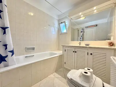 a bathroom with a tub and a toilet and a sink at Albufeira Balaia Golf Vilage 8 With Pool by Homing in Albufeira