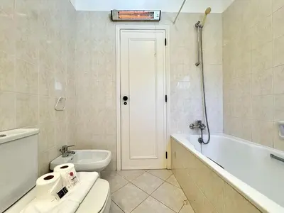 a bathroom with a toilet and a tub and a sink at Albufeira Balaia Golf Vilage 8 With Pool by Homing in Albufeira