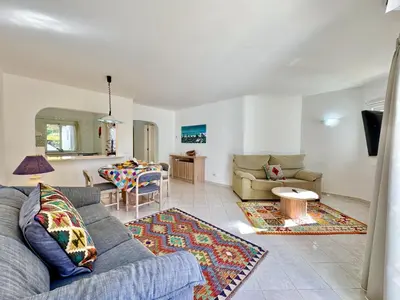 a living room with a couch and a table at Albufeira Balaia Golf Vilage 8 With Pool by Homing in Albufeira
