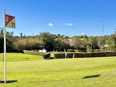 a flag in the middle of a golf course at Albufeira Balaia Golf Vilage 8 With Pool by Homing in Albufeira