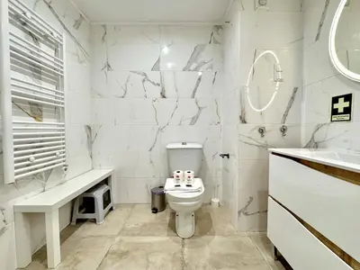 a white bathroom with a toilet and a sink at Vilamoura Central Beach 1 With Pool by Homing in Vilamoura