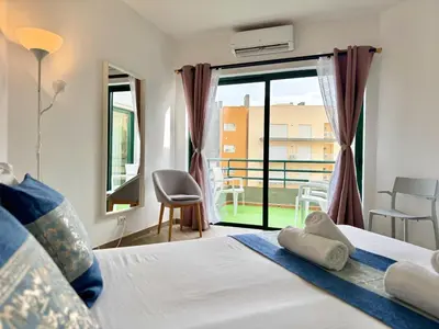 a bedroom with a bed and a window with a view at Vilamoura Central Beach 1 With Pool by Homing in Vilamoura