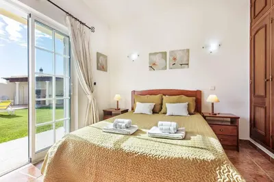 a bedroom with a bed with two towels on it at Villa Portela in Loulé