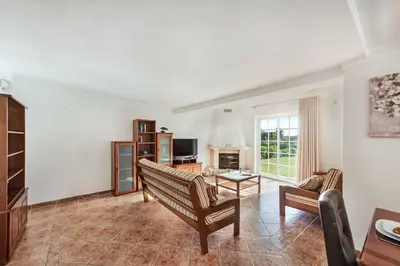 a living room with a couch and a table at Villa Portela in Loulé