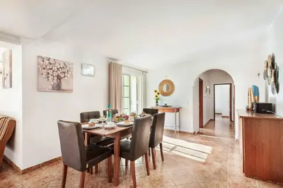 a dining room with a table and chairs at Villa Portela in Loulé