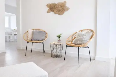 two chairs and a table in a living room at Varanda da Baixa, cosy apartment, top location, private terrace, barbecue, AC and Wi-Fi in Faro