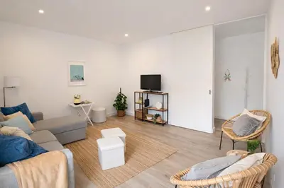 a living room with a couch and a tv at Varanda da Baixa, cosy apartment, top location, private terrace, barbecue, AC and Wi-Fi in Faro
