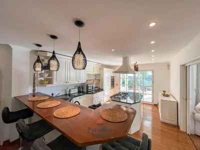 a kitchen and dining room with a wooden table at 7 Bedrooms, Main House, Bungalow, Private Pool in Fonte da Murta