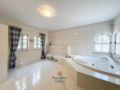 a large bathroom with a tub and a toilet at 7 Bedrooms, Main House, Bungalow, Private Pool in Fonte da Murta
