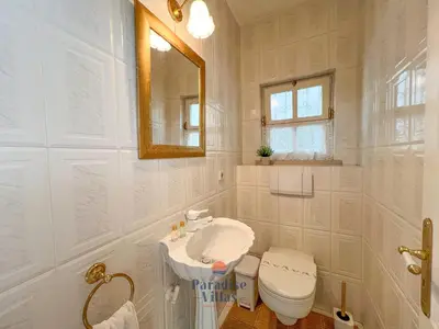 a white bathroom with a toilet and a sink at 7 Bedrooms, Main House, Bungalow, Private Pool in Fonte da Murta