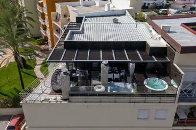 a patio with a swimming pool on a roof at Penthouse Grand Noir in Guia