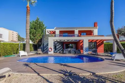 a villa with a swimming pool in front of a house at Villa Gale by Vintage Travel in Galé