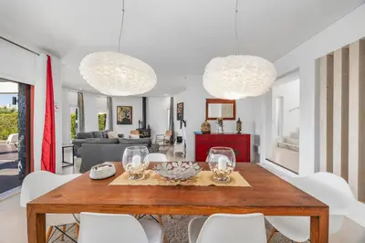 a dining room with a table and white chairs at Villa Gale by Vintage Travel in Galé
