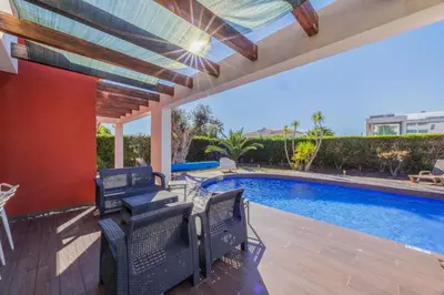 a patio with chairs and a swimming pool at Villa Gale by Vintage Travel in Galé