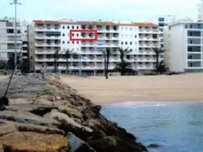 a building on the beach next to the ocean at Apartment NASCER-DO-SOL by Interhome in Quarteira
