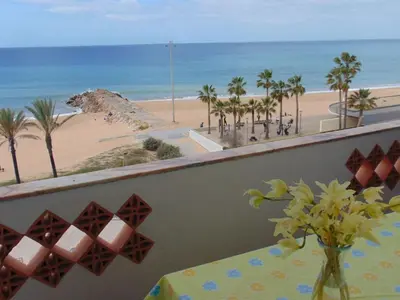a table on a balcony with a view of the beach at Apartment NASCER-DO-SOL by Interhome in Quarteira