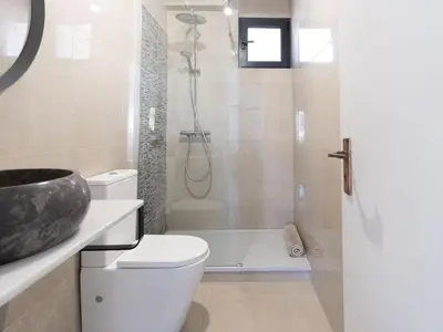 a bathroom with a shower and a toilet and a sink at Holiday Home Aldeia Do Mar by Interhome in Vilamoura