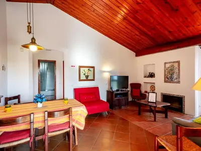 a living room with a table and a red couch at Holiday Home Lotus Villa 2- Albufeira by Interhome in Albufeira
