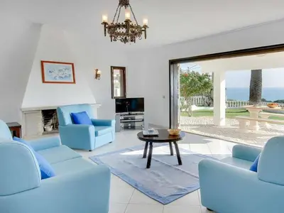 a living room with blue chairs and a table at Holiday Home Chalet Villa Brigida mit privatem Pool by Interhome in Albufeira