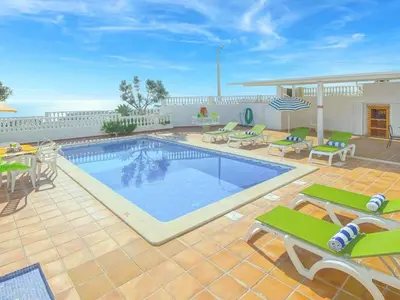 a swimming pool with tables and chairs on a patio at Holiday Home Chalet Villa Brigida mit privatem Pool by Interhome in Albufeira
