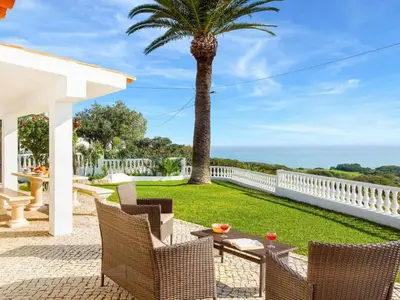 a patio with a table and chairs and a palm tree at Holiday Home Chalet Villa Brigida mit privatem Pool by Interhome in Albufeira