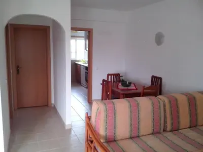 a living room with a couch and a table at Apartment Wohnung mit Terrasse by Interhome in Albufeira