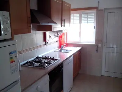 a small kitchen with a stove and a sink at Apartment mit Terrasse by Interhome in Albufeira