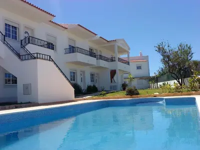 a swimming pool in front of a house at Apartment Wohnung mit Terrasse by Interhome in Albufeira
