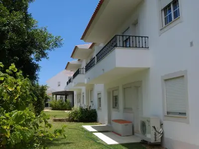 a white building with a balcony on the side at Apartment Wohnung mit Balkon by Interhome in Albufeira