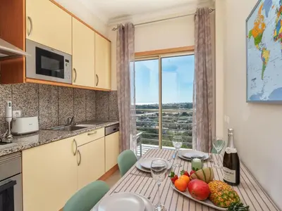 a kitchen with a table with fruit and wine glasses at Apartment Elena 2 mit Blick auf das Wasser by Interhome in Albufeira