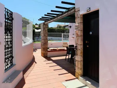 a house with a patio with a black door at Holiday Home Lotus Villa- Albufeira by Interhome in Albufeira