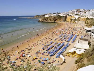 a beach with a lot of people and the ocean at Apartment mit Terrasse by Interhome in Albufeira